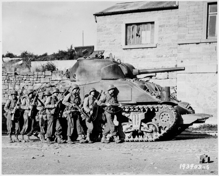 lossy-page1-1024px-Yanks_of_60th_Infantry_Regiment_advance_into_a_Belgian_town_under_the_protection_of_a_heavy_tank._-_NARA_-_531213.tif.jpg
